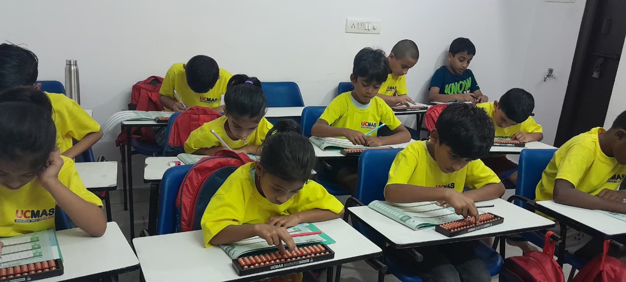 Children practicing abacus in a UCMAS classroom