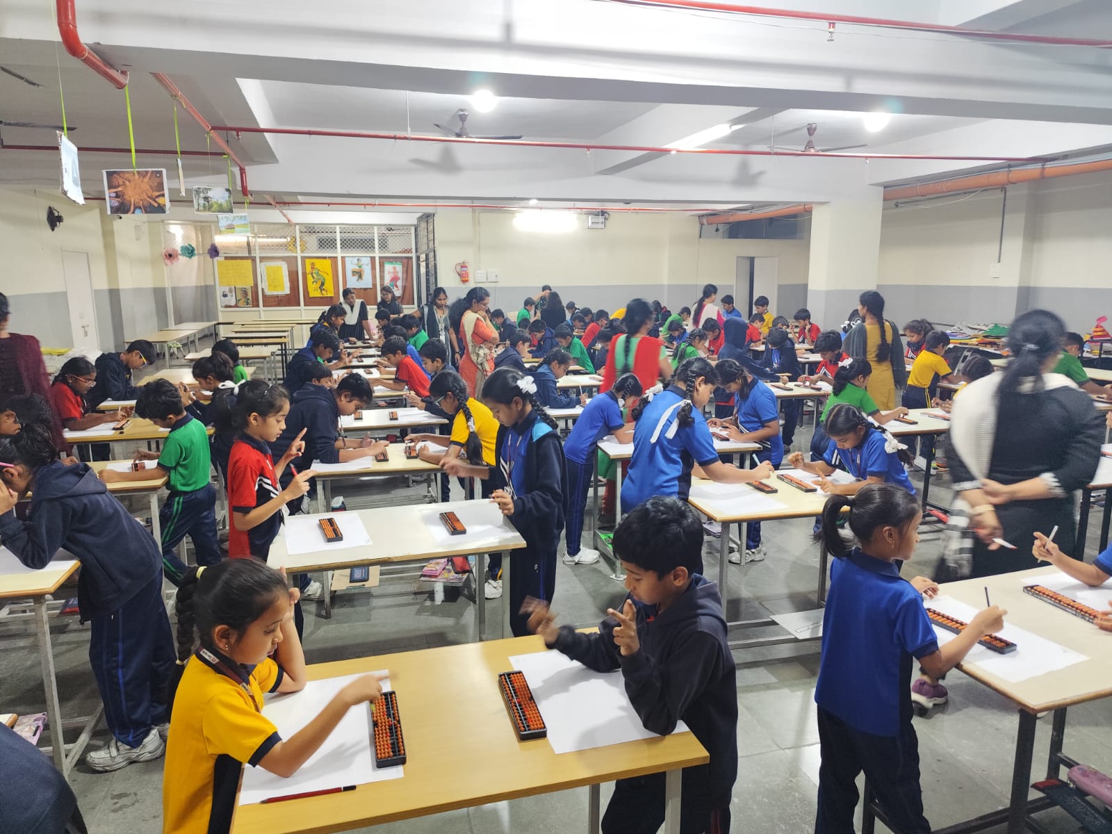 Students learning the UCMAS Abacus Programme for Schools in a bright classroom